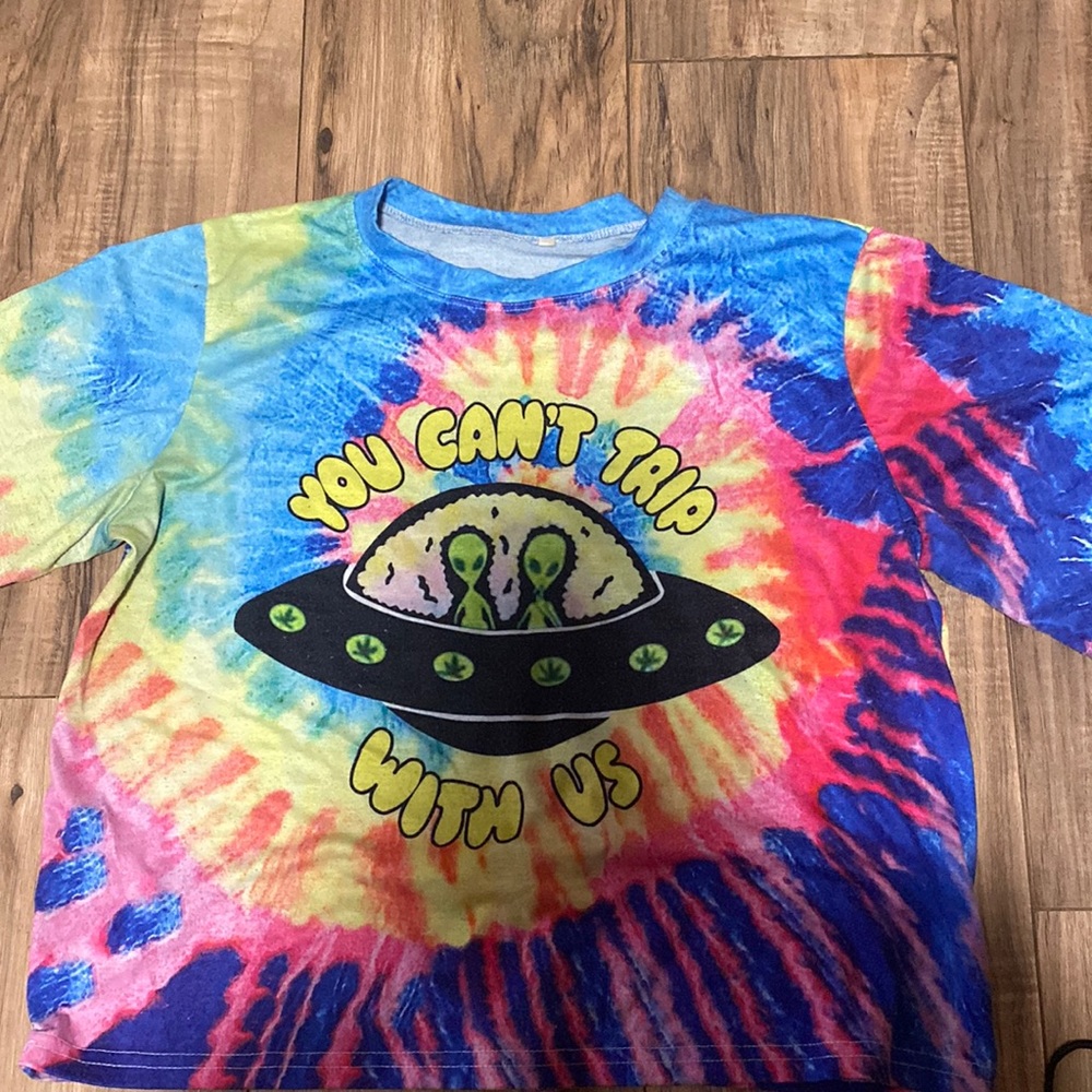 Tye Dye shirt, says "you cant trip with us"